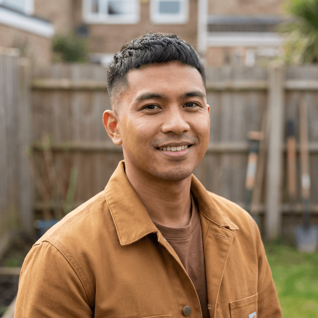 Tyler Nguyen standing in a garage beside his Toyota Supra build
